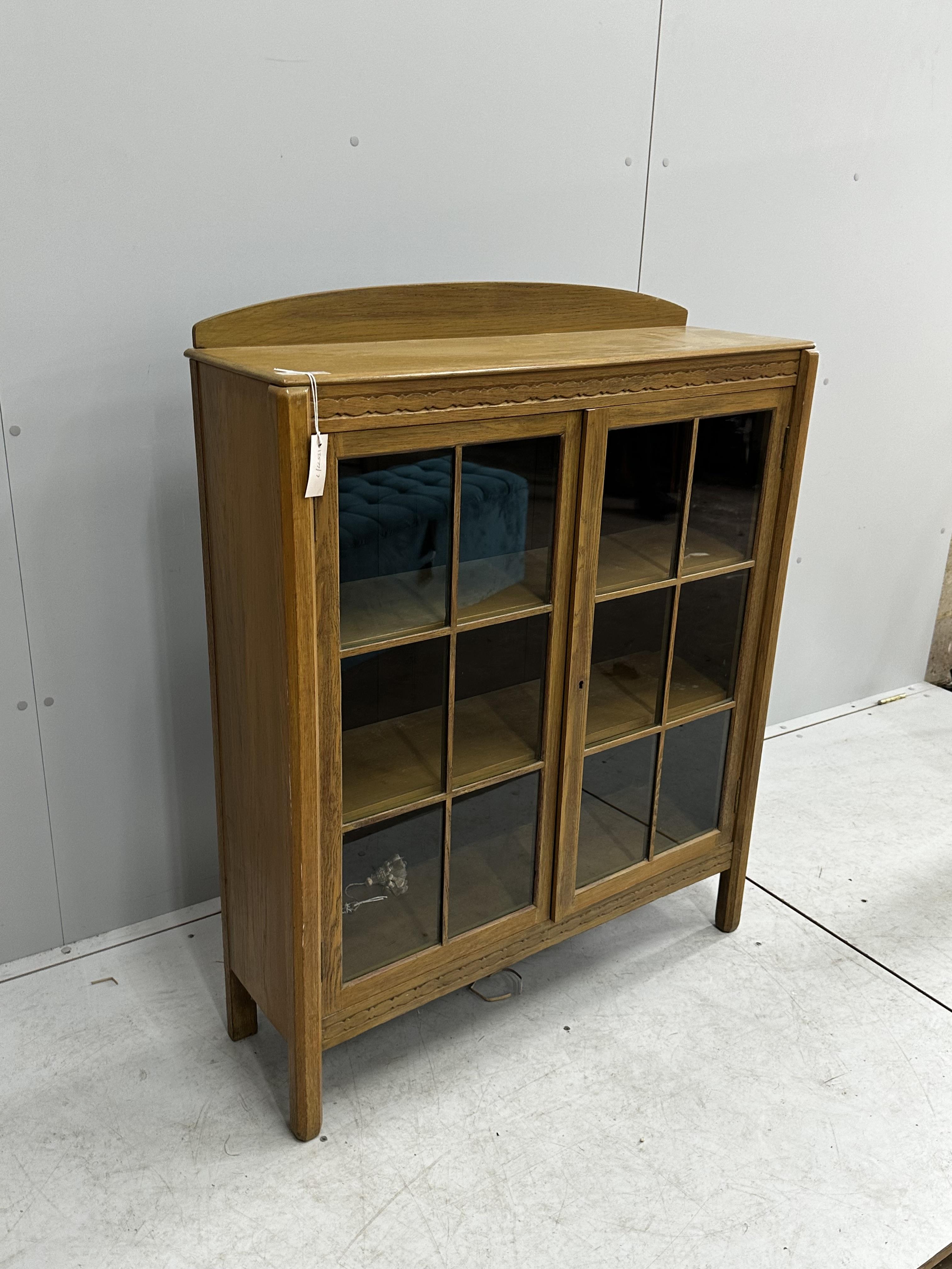 An early 20th century bleached oak glazed bookcase, width 91cm, depth 28cm, height 114cm